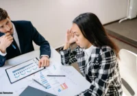 A photo of a stressed business owner looking at financial documents or a team brainstorming in a meeting room.