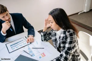 A photo of a stressed business owner looking at financial documents or a team brainstorming in a meeting room.